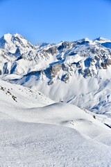 French alps on a sunny day by winter covered with snow