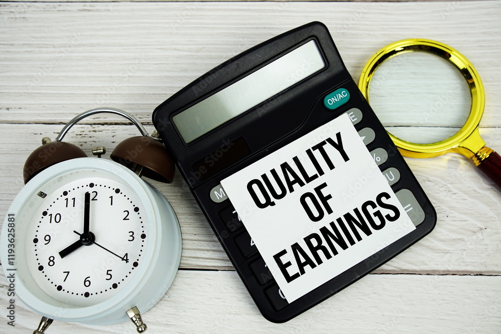 Poster quality of earnings text message with calculate, alarm clock and magnifying glass on wooden backgrou