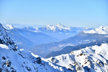 Winter scenery of French alps with tones of blue under snow
