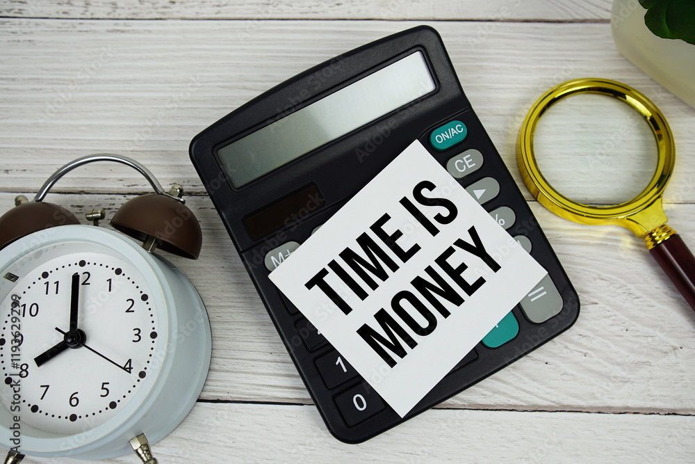 Poster time is money text message on sticky note with magnifying glass, alarm clock and calculator on woode