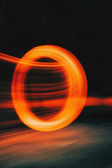 Vibrant Circular Motion: Dynamic Orange Light Spiral Captured in Long Exposure Abstract Artistic Design