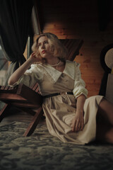Obraz premium Woman sitting next to the window in house, bad mood, mental health problems