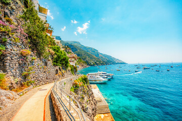 Naklejka premium Positano coastline in south of Italy, vertiginous cliffs adorned with colorful villages, turquoise waters. Small town Positano on Amalfi Coast near Neapol, Italy