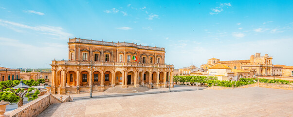 view in Noto, with the Basilica Minore di San Nicolo and Palazzo Ducezio, Sicily, Italy.