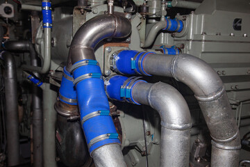 Connecting steel pipes on a marine diesel generator.