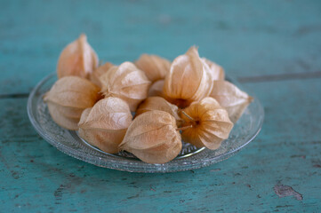 Physalis peruviana ripened orange yellow cape gooseberry goldenberry edible tasty ingredient fruits spread on wooden background