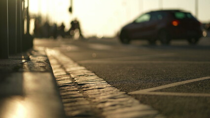Blurred city streets sidewalk during golden hour sunset time