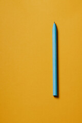 blue paper pen on yellow background
