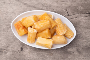 Traditional brazilian fried manioc in a plate over wooden table