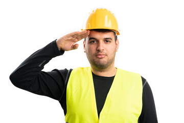 Constructor making military salute wearing hardhat and vest
