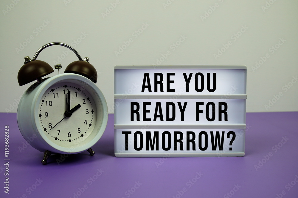Poster are you ready for tomorrow? text on led lightbox with alarm clock on purple background