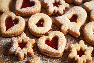 Baked Linzer Christmas cookies filled with strawberry jam