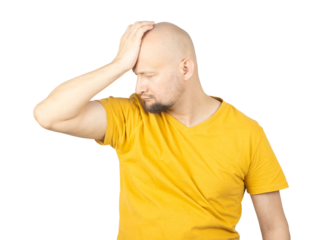 Frustrated Man in Yellow T-Shirt Holding Head in Distress