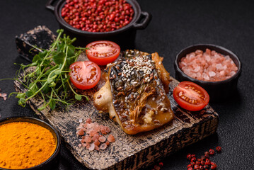 Grilled mackerel fillet pieces with vegetables, salt and spices