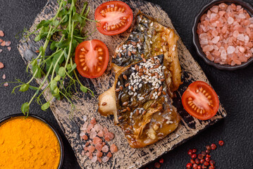 Grilled mackerel fillet pieces with vegetables, salt and spices