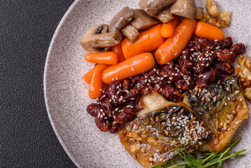 Grilled mackerel fillet pieces with vegetables, salt and spices