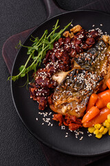 Grilled mackerel fillet pieces with vegetables, salt and spices