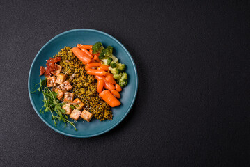 Quinoa bowl with tofu, steamed vegetables, grains, seeds and spices