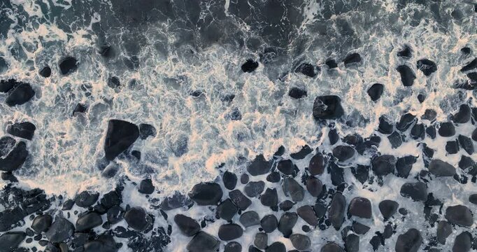 Water Background Surface of frosty stones and rocks and sea waves on the artic beach shore