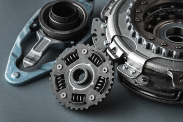 New clutch kit of the automatic gearbox DSG prepared to replace. Spare parts for a modern car isolated on grey background. Car repair and service concept