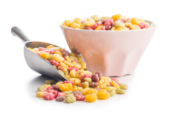 Colorful breakfast cereals in the shape of various fruit in scoop isolated on white background.