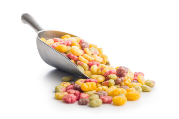 Colorful breakfast cereals in the shape of various fruit in scoop isolated on white background.