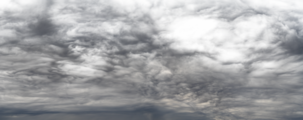 Panorama of dramatic storm clouds that fade to transparent in light areas near top right
