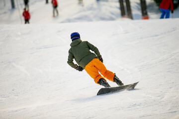 Extreme ski slope slalom snowboarder. Fast snowboarder of skilled move driving downhill skiing...