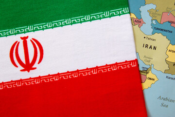 Iran national flag on the paper world map.