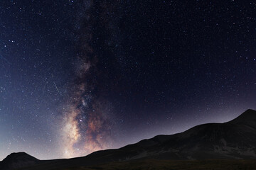 Beautiful night landscape, Bright Milky Way galaxy over the mountains, starry sky.