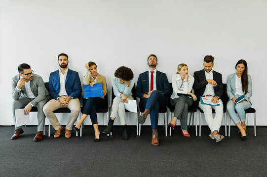 man business chair sitting waiting businessman candidate recruitment office businesswoman woman businessperson job young interview line employee career row hall colleague