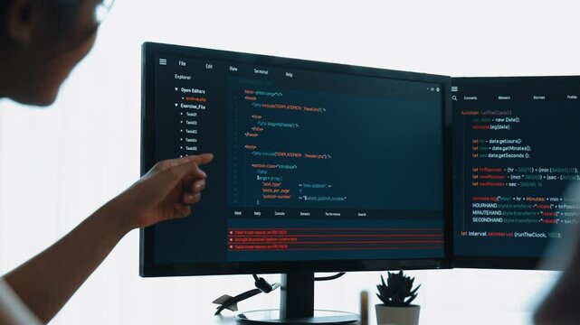 Slow motion back end software developer engineer for computer programming working together on debugging writing computing code, solving complex algorithms display on monitor in office. Burgeoning