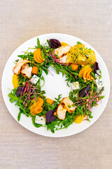 Creative salad arrangement with colorful ingredients and fresh greens