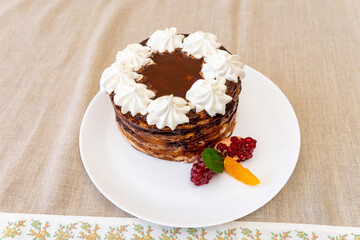 Delicious chocolate cake with whipped cream and fresh berries on a plate