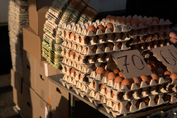 Chicken eggs in cardboard boxes are sold at the market