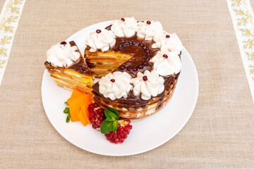 Delightful layered cake with cream and fruit served on a dining table