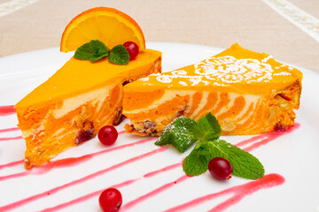 Creamy orange mousse dessert with cranberries and mint garnish