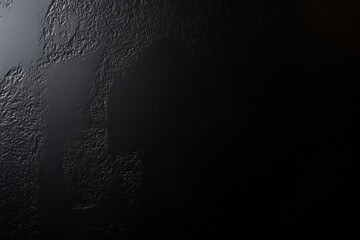 An abstract background with a rough surface and gradient lighting from grey to black make for simple backgrounds and presentations.