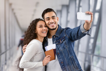 Time For Journey. Portrait Of Cheerful Middle Eastern Couple Taking Selfie With Smartphone In...