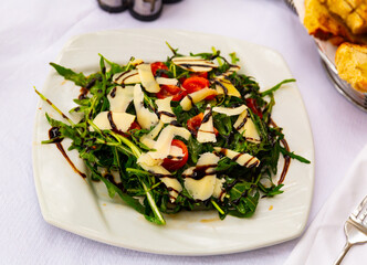 Delicious vegetable salad with tomato, arugula, cheese and balsamic sauce, albanian cuisine