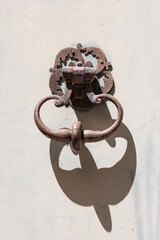 Arles, Bouches-du-Rhone, Provence-Alpes-Cote d'Azur, France. Rusted iron door knocker in Provence.