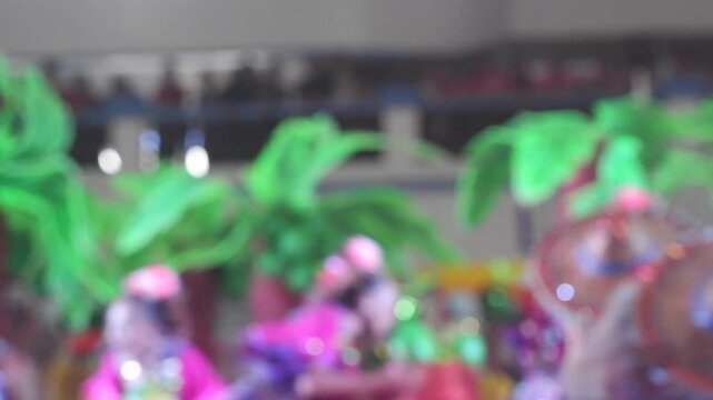 Dancers in colorful native costumes perform exuberantly to honor a Patron Saint during the annual coconut festival celebration. Blurs