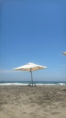 beach with umbrella and chairs