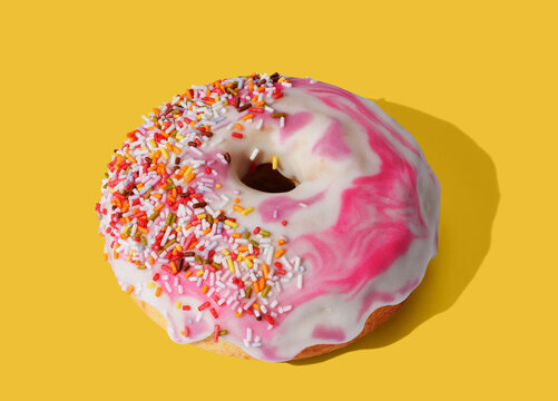 Red donut on yellow pastel background