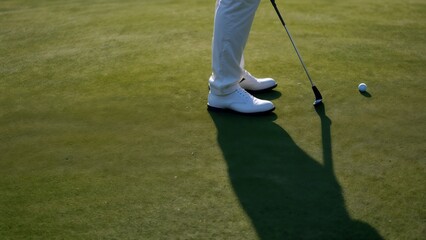 golfer on the golf course, taking a shot from the tee against the sunset backdrop. An ideal shot for illustrating an active lifestyle, women's sports, and golf.