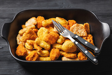 fried chunks, bites, tenders, nuggets on a dish