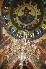 Obraz premium Thira, Santorini, Greece. Greek orthodox church and interior painting and chandelier