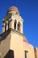 Fototapeta premium Corfu, Greece. Red church dome, terra cotta walls and arched windows
