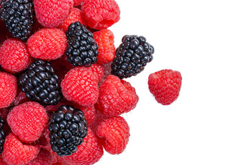 Large pile of red and black raspberries and blackberries - close-up from above on transparent background