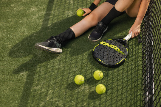 Padel tennis racket. Sport court and balls. Download a high quality photo with paddle for the design of a sports app or social media advertisement